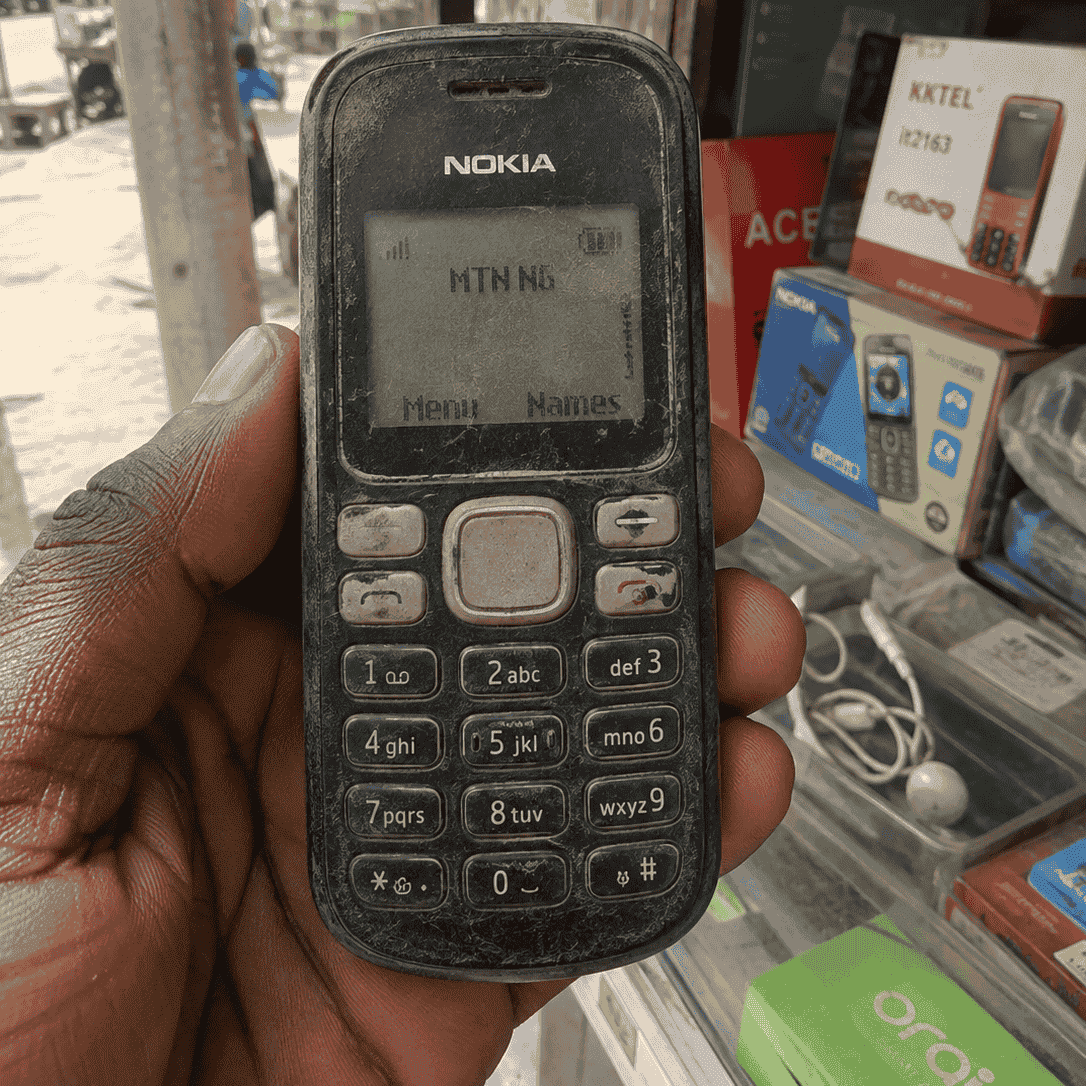 A worn Nokia-style feature phone on MTN Nigeria, the hardware Ticket IT USSD was built for